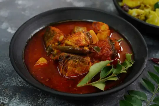 A traditional Kerala beef dry fry dish served with onion and curry leaves, prepared at UK Meal Club
